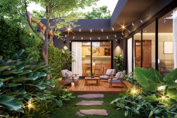 Modern contemporary style small wooden terrace in lush garden with house interior background 3d render, there are green wall fence decorated with white outdoor furniture and string light